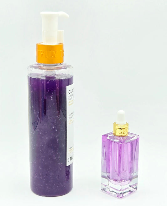 Two purple bath products, a large pump bottle and a small dropper bottle, on a white background.