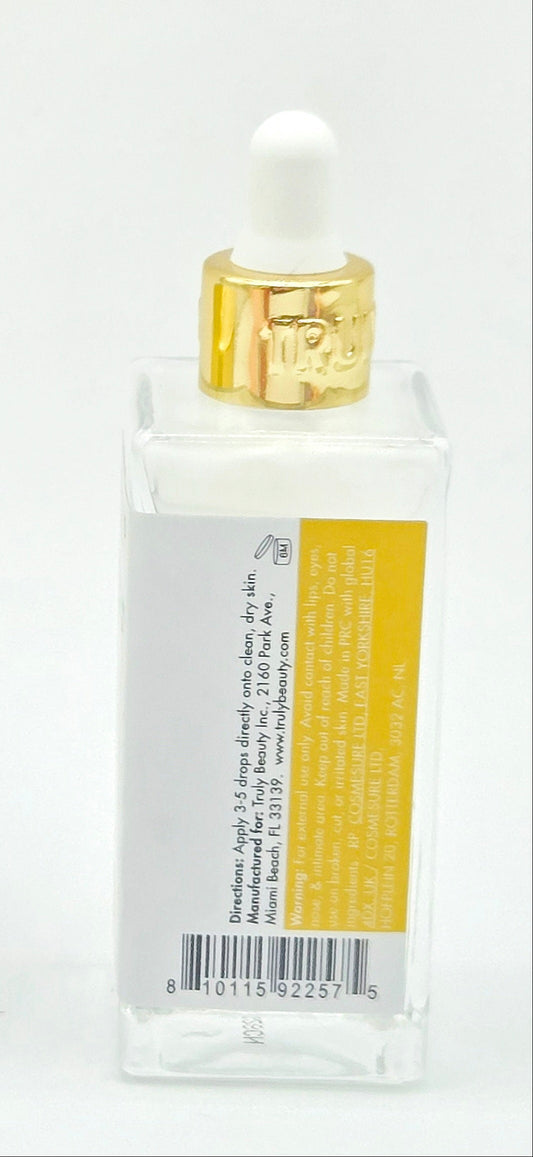 Dropper bottle with gold trim and labels on a white background