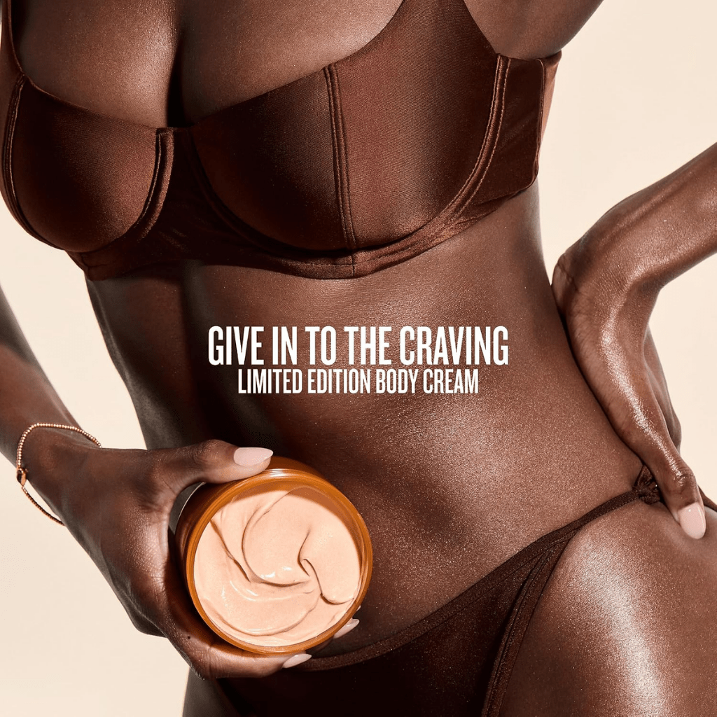 A model in a brown outfit holding an open jar of Cheirosa 71 Body Cream beside limited-edition promotional text.