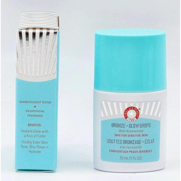 First Aid Beauty Bronze + Glow Drops with Niacinamide, a white bottle with a light blue cap, next to its matching blue and silver box.
