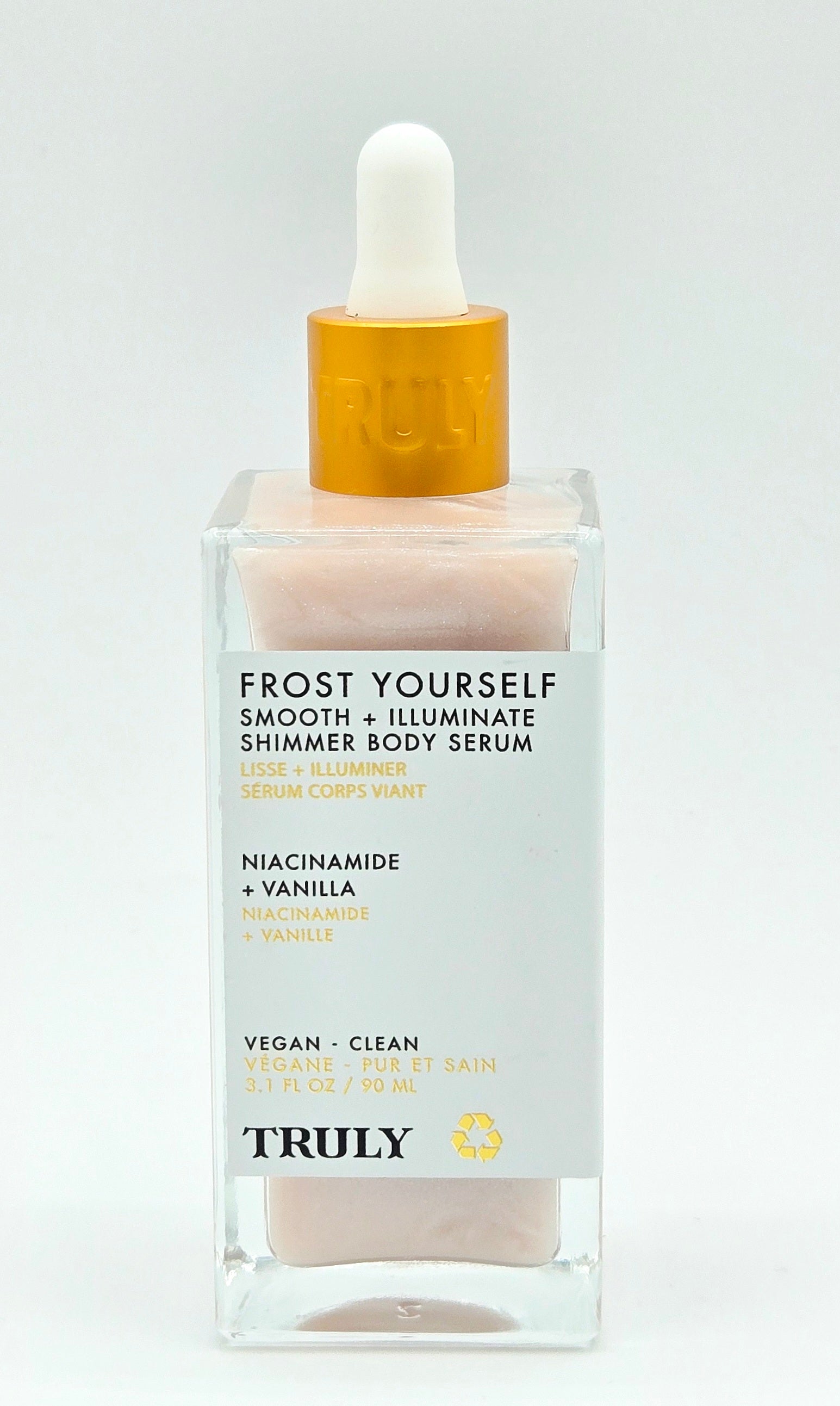 Body serum bottle with dropper labeled 'TRULY' on a light gray background