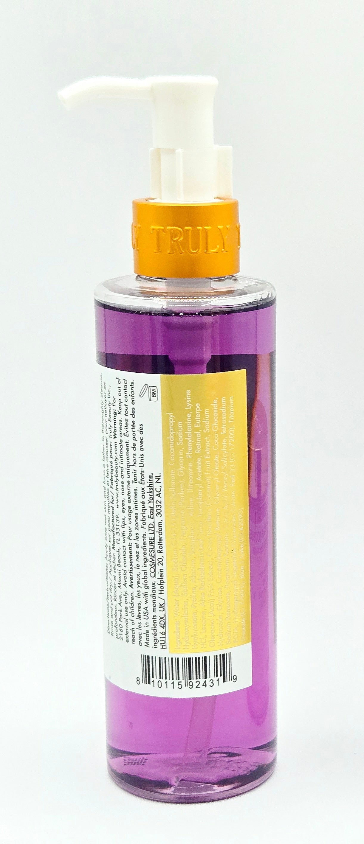 Purple pump bottle with gold trim on white background