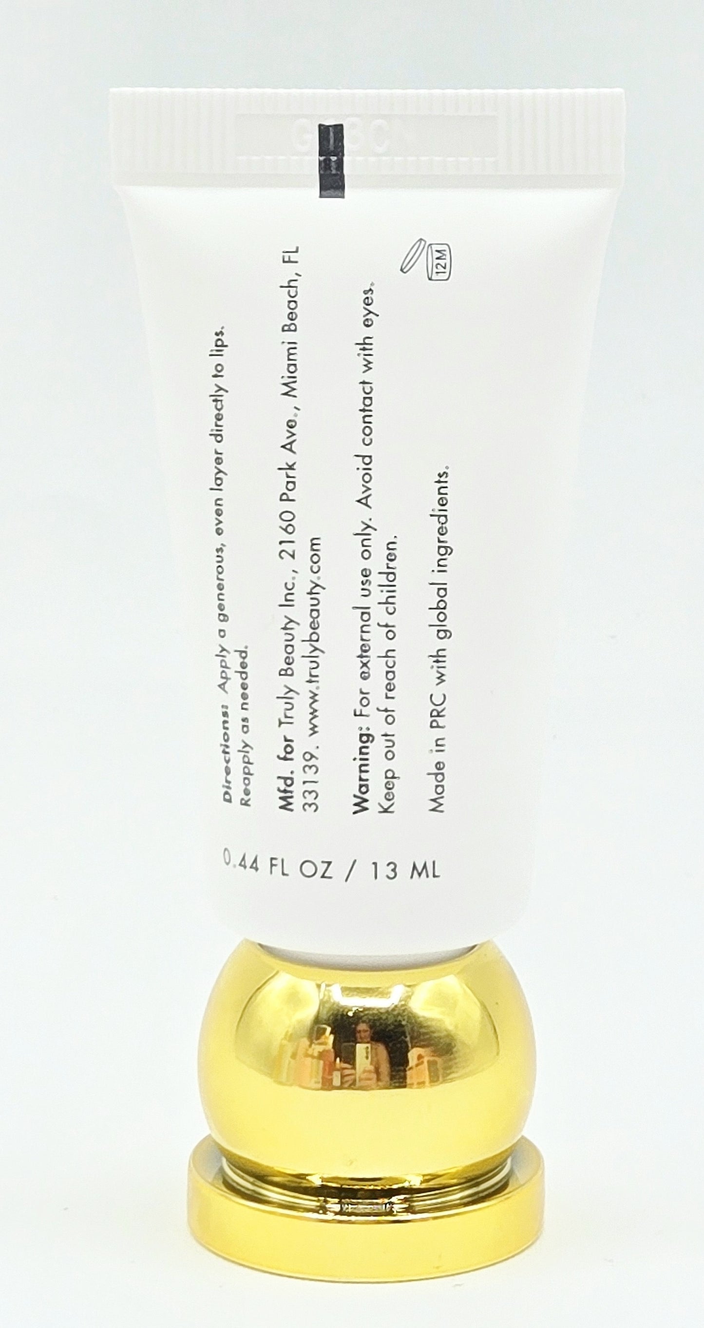 Small tube with gold cap on a white background
