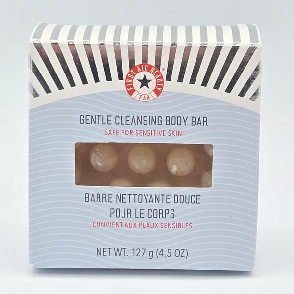 First Aid Beauty Gentle Cleansing Body Bar in a striped box with a clear window showing the bar.