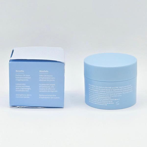 Light blue First Aid Beauty Hydrating Dewy Gel Cream jar and box with white text on a white surface.