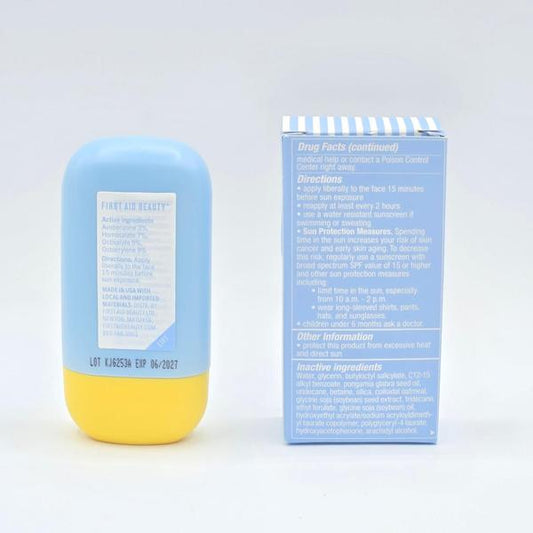 First Aid Beauty Hydrating Sunscreen Milk in a light blue bottle with a yellow base, next to its blue and white striped box.