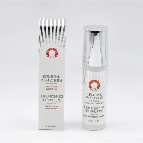 First Aid Beauty 0.3% Retinol Complex Serum, 1 fl oz, in a white bottle with a silver pump and matching box.