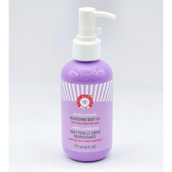 First Aid Beauty After Shower Nourishing Body Oil in a 6 oz lavender bottle with a white pump.