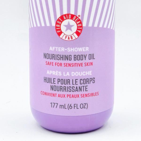 First Aid Beauty After Shower Nourishing Body Oil, 6 oz, in a purple bottle with white stripes and red logo.