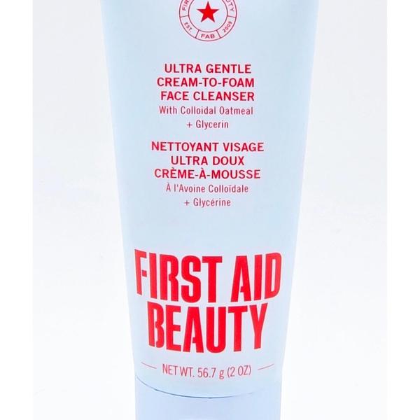 First Aid Beauty Ultra Gentle Cream-to-Foam Face Cleanser 2 oz tube with red and black text on white.