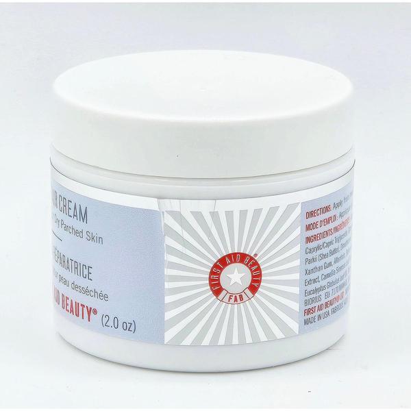 White jar of First Aid Beauty Ultra Repair All Over Cream (2 fl oz) with a red and white logo.