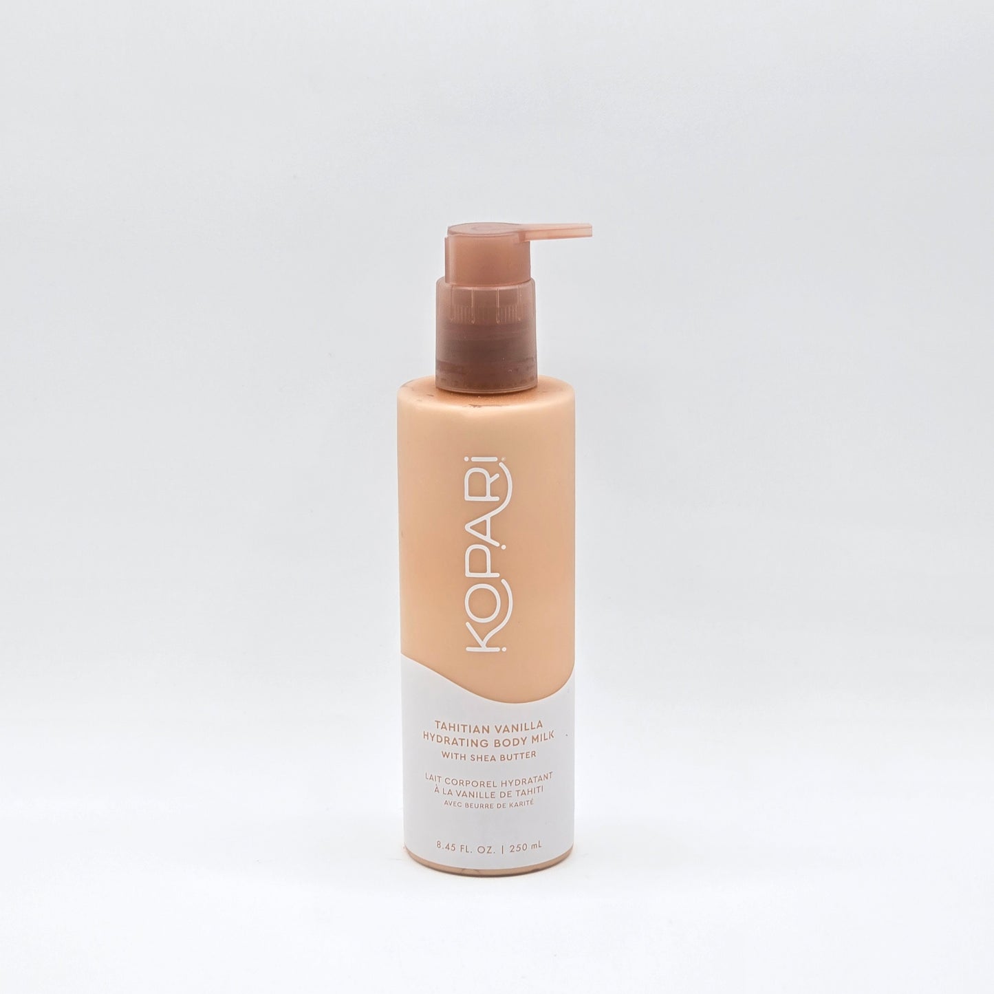 Kopari Tahitian Vanilla Hydrating Body Milk, 8.45 fl oz, in a peach-colored pump bottle.