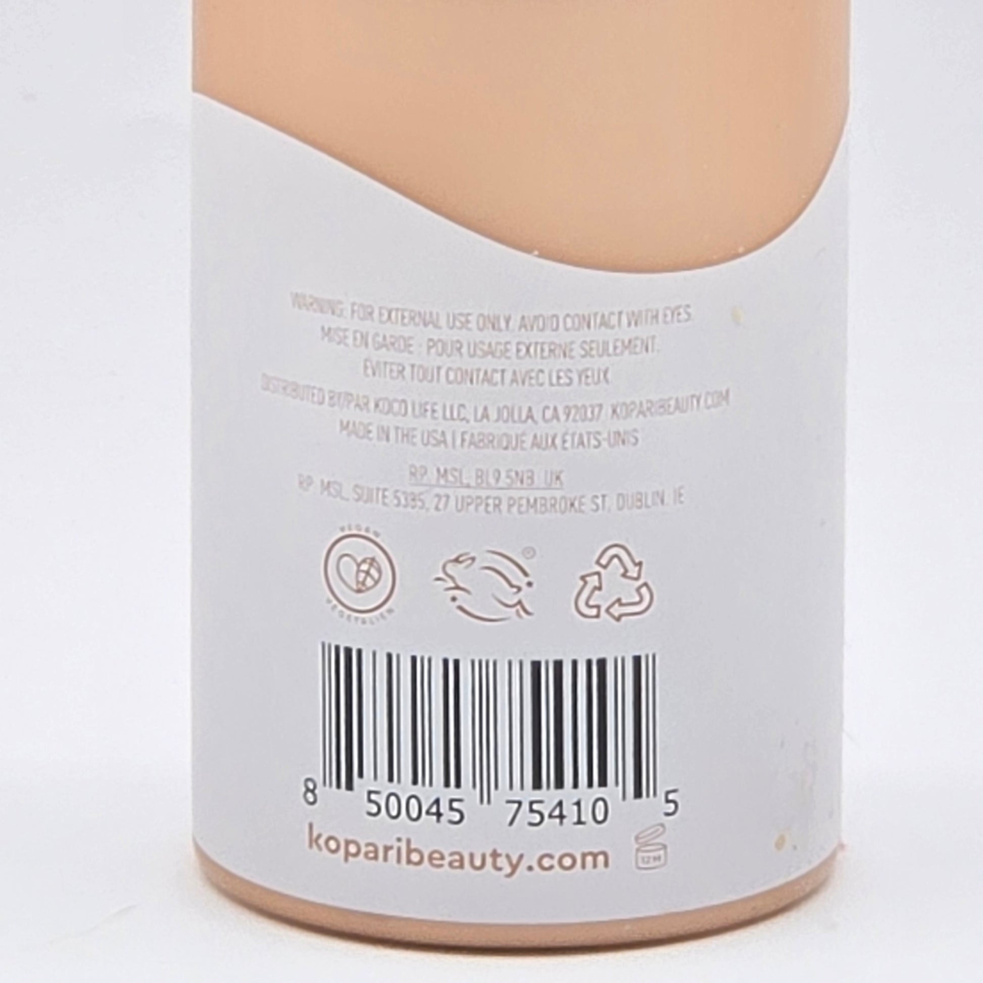 Back of Kopari Tahitian Vanilla Hydrating Body Milk bottle, showing barcode, vegan, cruelty-free, and recycling symbols.
