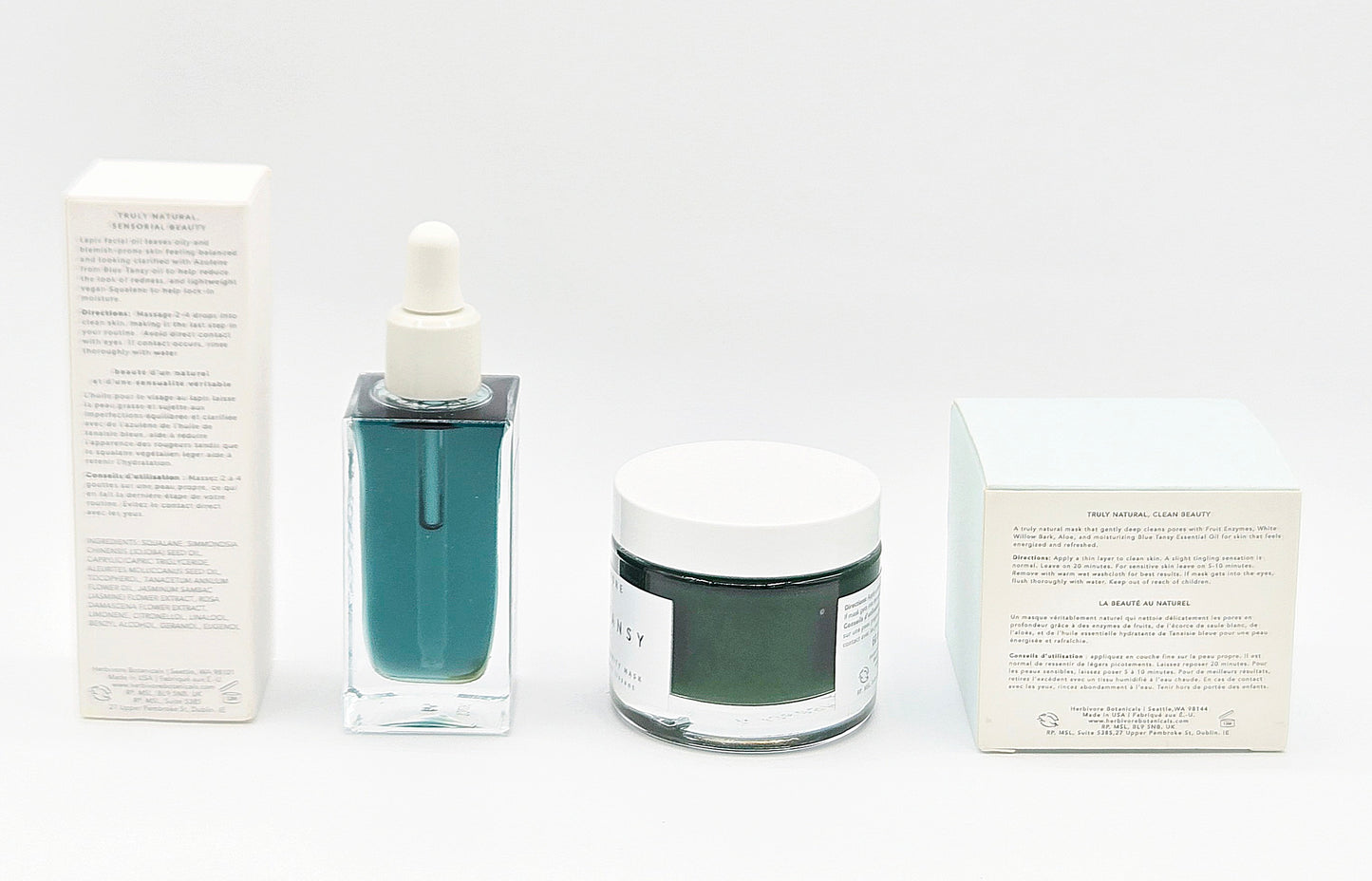 Cosmetic products including a bottle, jar, and boxes on a white background