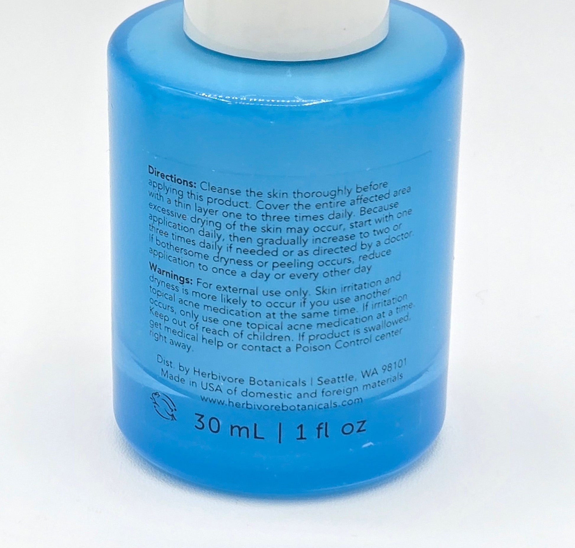 Blue bottle with white cap on a white background