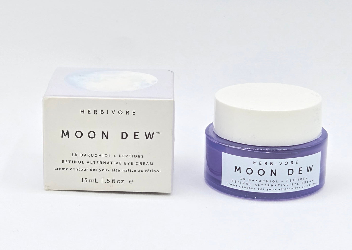 Herbivore Moon Dew eye cream jar and packaging on a white background