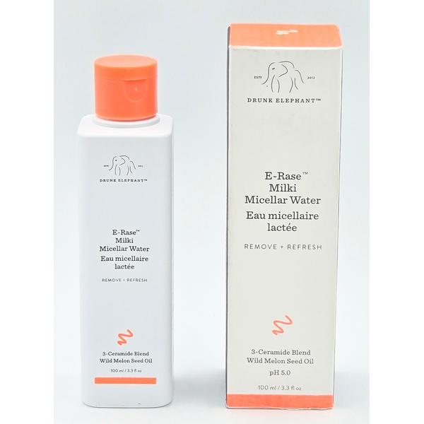Drunk Elephant E-Rase Milki Micellar Water, white bottle with orange cap next to its white and orange box.