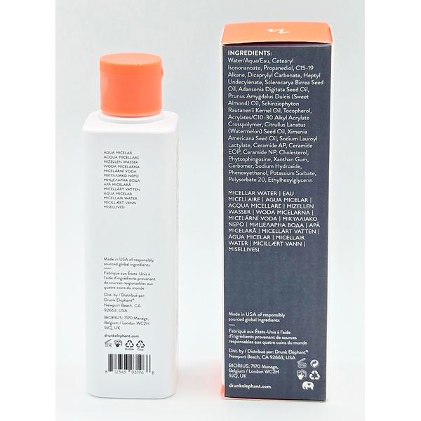 Drunk Elephant Micellar Water bottle with orange cap next to its black and orange ingredient list box.