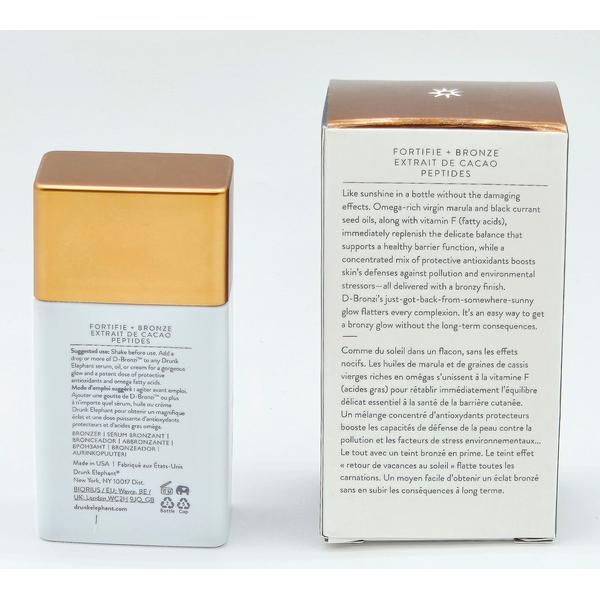 Drunk Elephant D-Bronzi Anti-Pollution Sunshine Drops, white bottle with gold cap, next to its brown and white box.