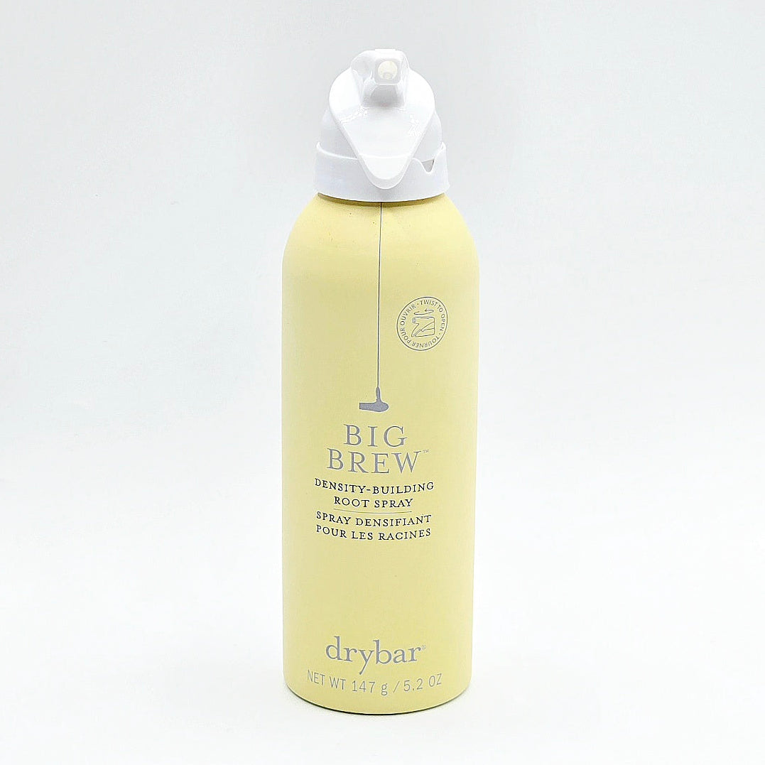 A Drybar Big Brew Density-Building Root Spray bottle in pale yellow with a white pump dispenser, set against a plain white background.
