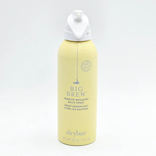 A Drybar Big Brew Density-Building Root Spray bottle in pale yellow with a white pump dispenser, set against a plain white background.
