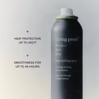Uncapped Living Proof PhD Heat Styling Spray can beside claims of heat protection up to 450°F and smoothness up to 48 hours