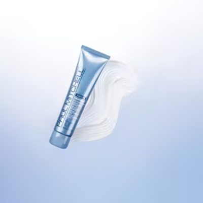 Paul Mitchell Bond Rx Treatment blue tube beside a white cream swatch on a pale blue background