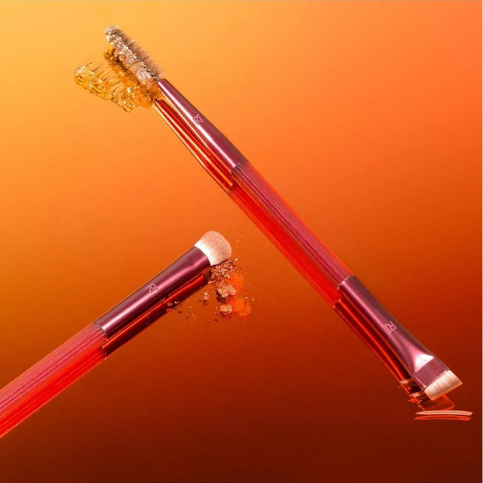 Close-up of Solar Power eye and brow brushes with makeup textures