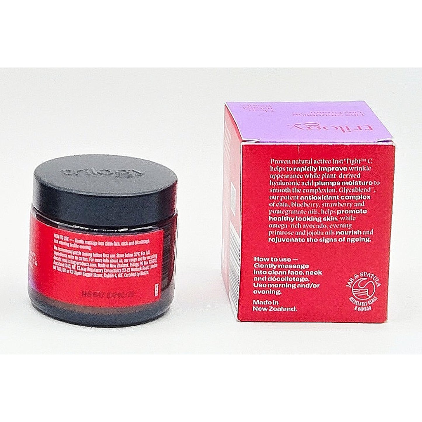 Cosmetic jar with red label and black lid next to its packaging box on a white background