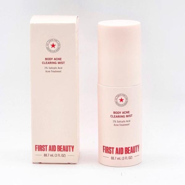 First Aid Beauty Body Acne Clearing Mist, a 3 fl oz pale pink bottle and matching box with red text.