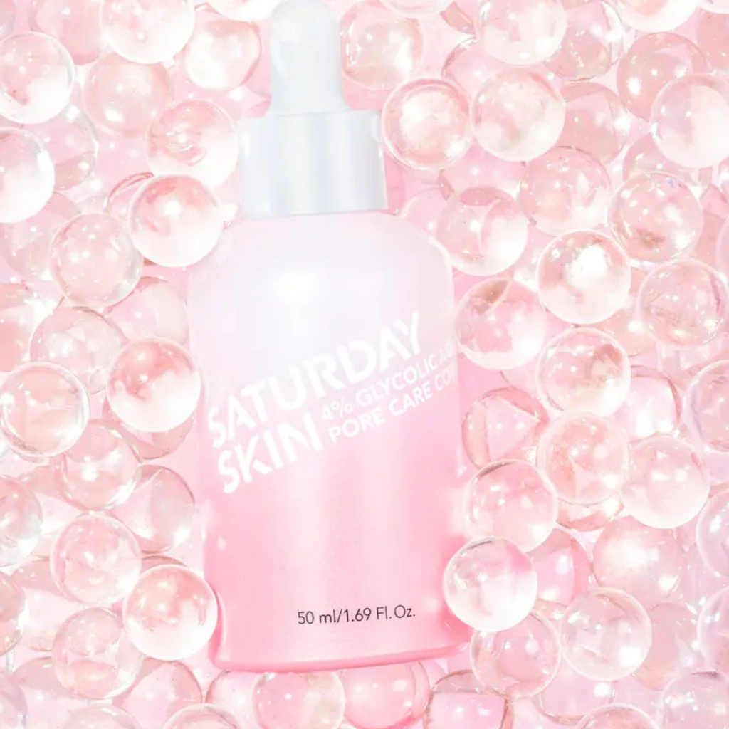 Pink Pore Active Treatment bottle displayed among translucent beads