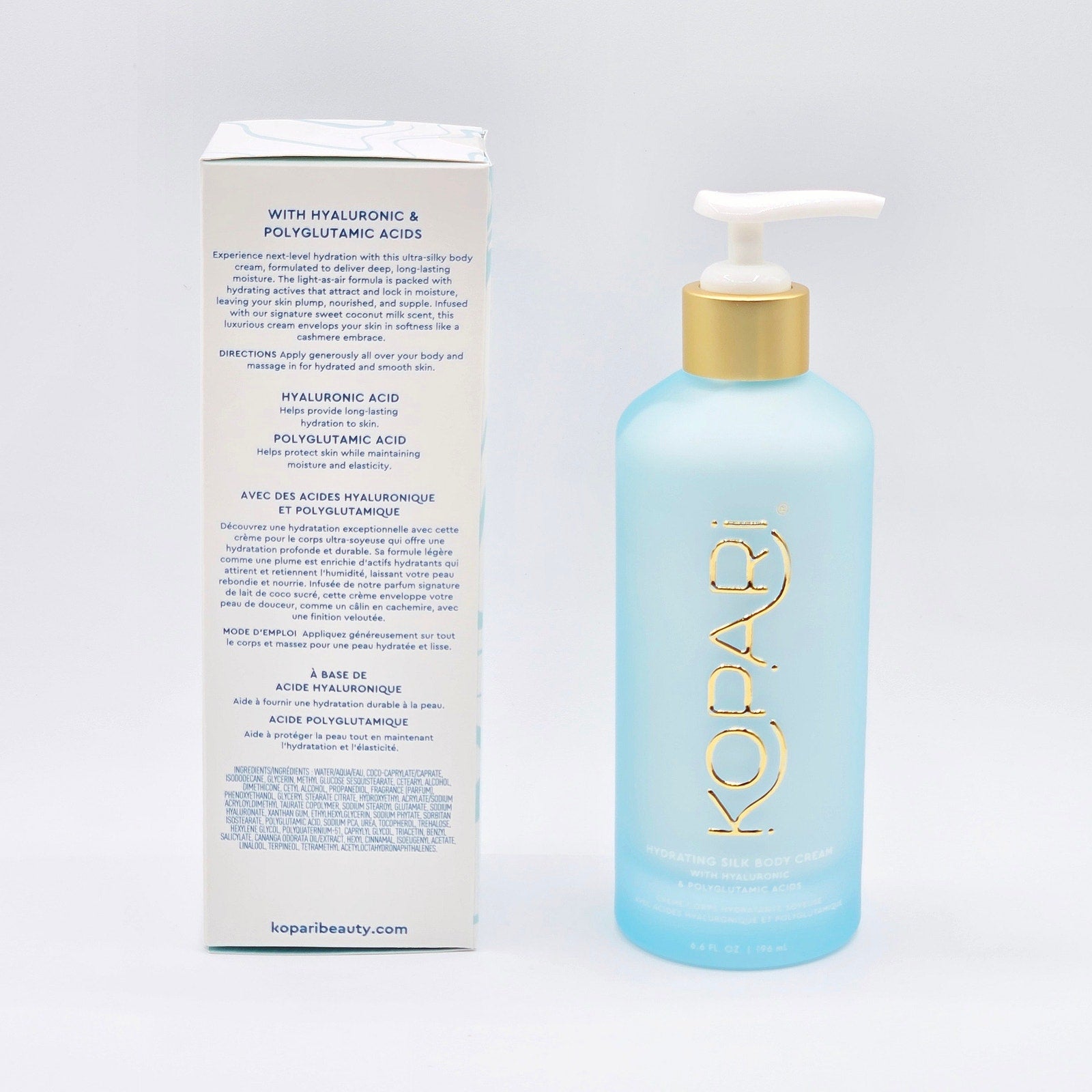 Rear label of Kopari Hydrating Silk Body Cream box beside the 6.6 fl oz glass pump bottle