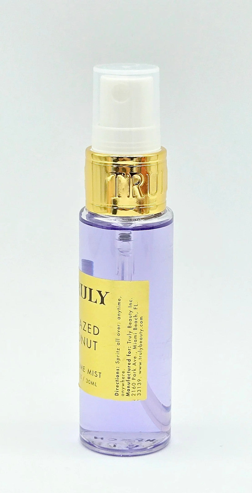 Purple pump bottle with gold trim on white background