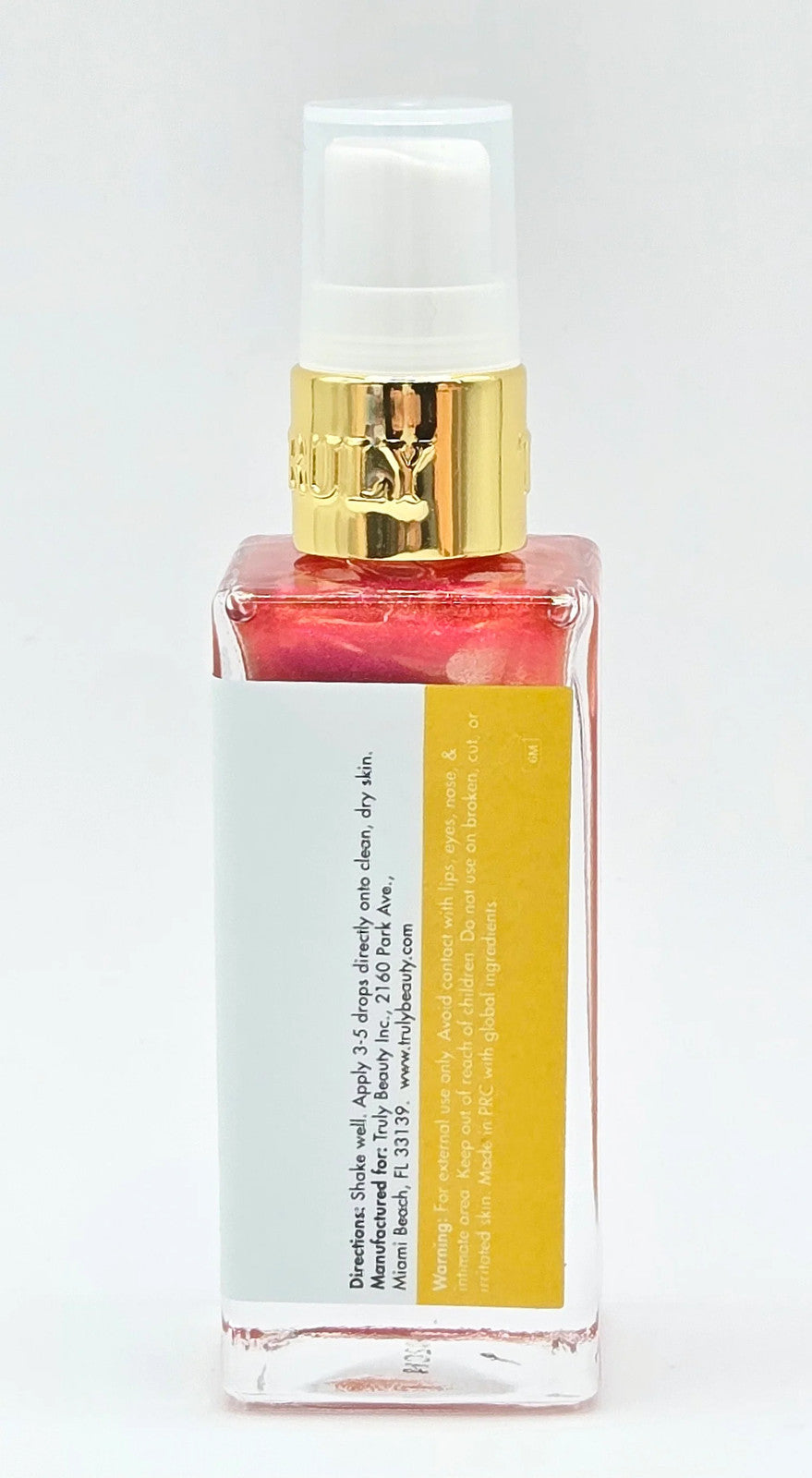 Red pump bottle with gold trim on white background