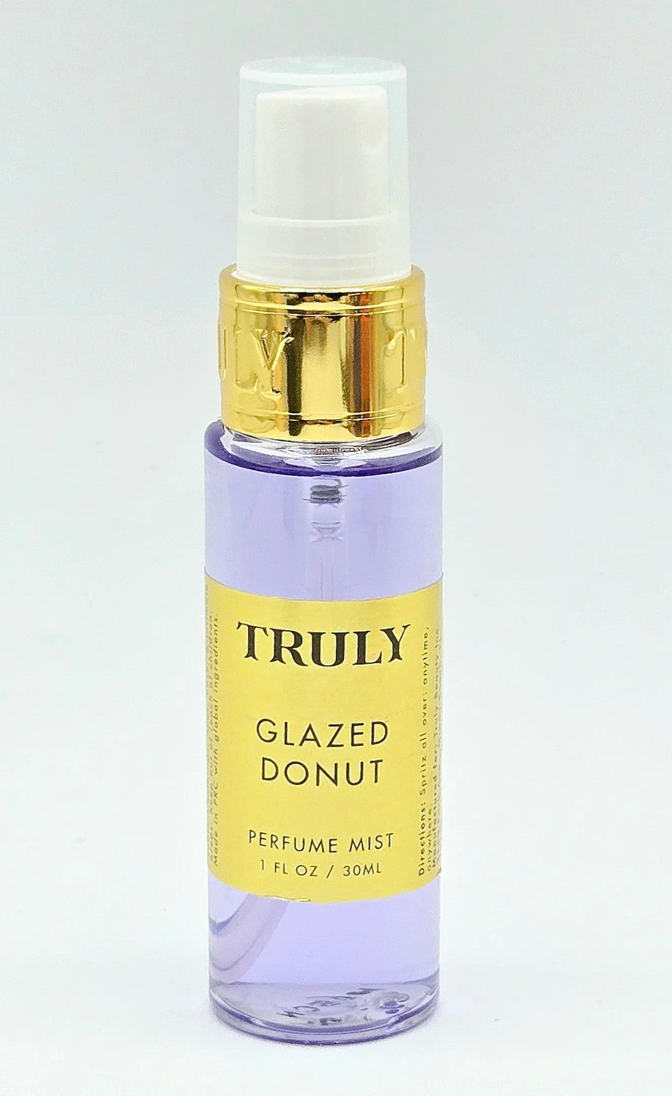 Purple pump bottle with gold trim on a white background