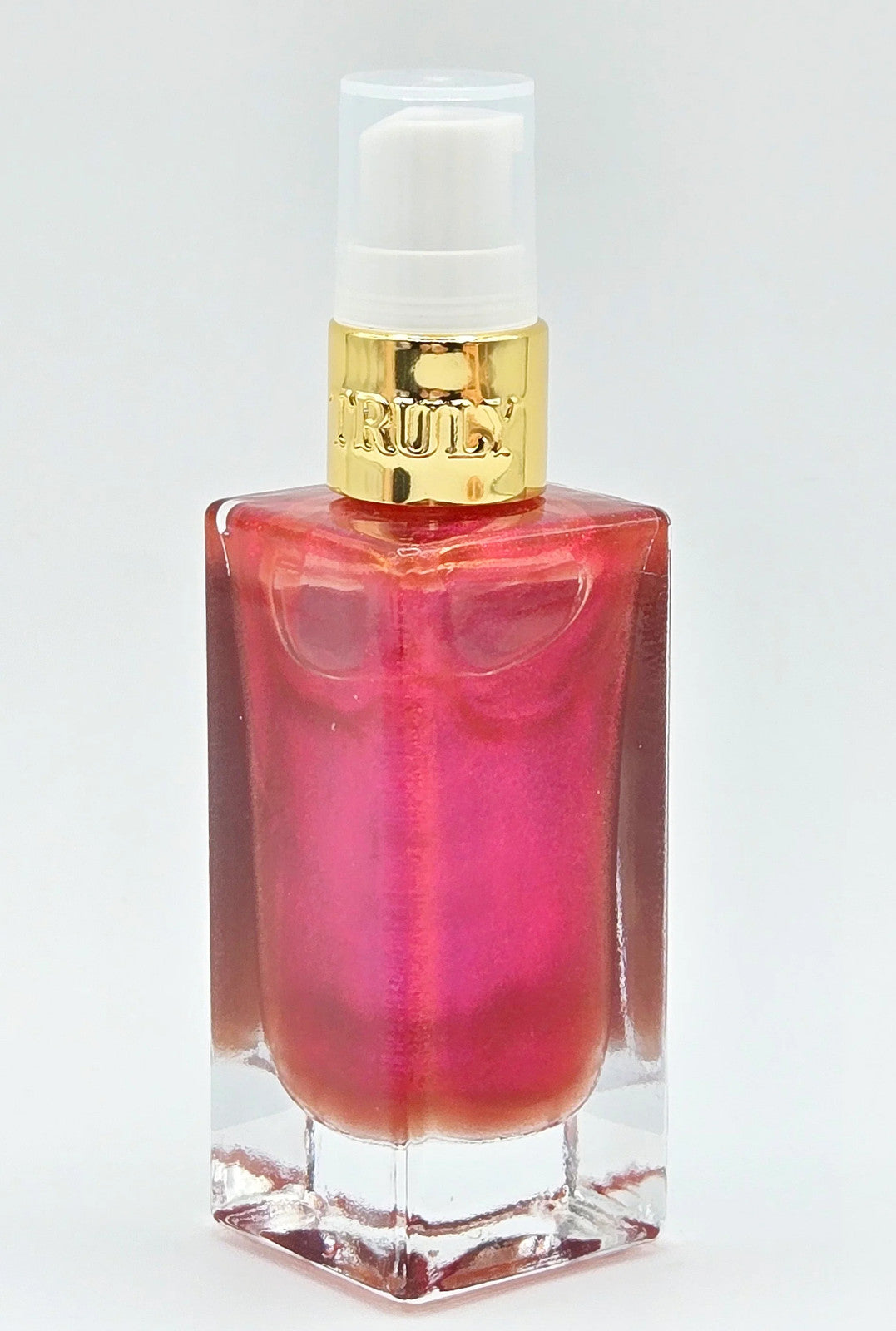 Red pump bottle with gold trim on white background