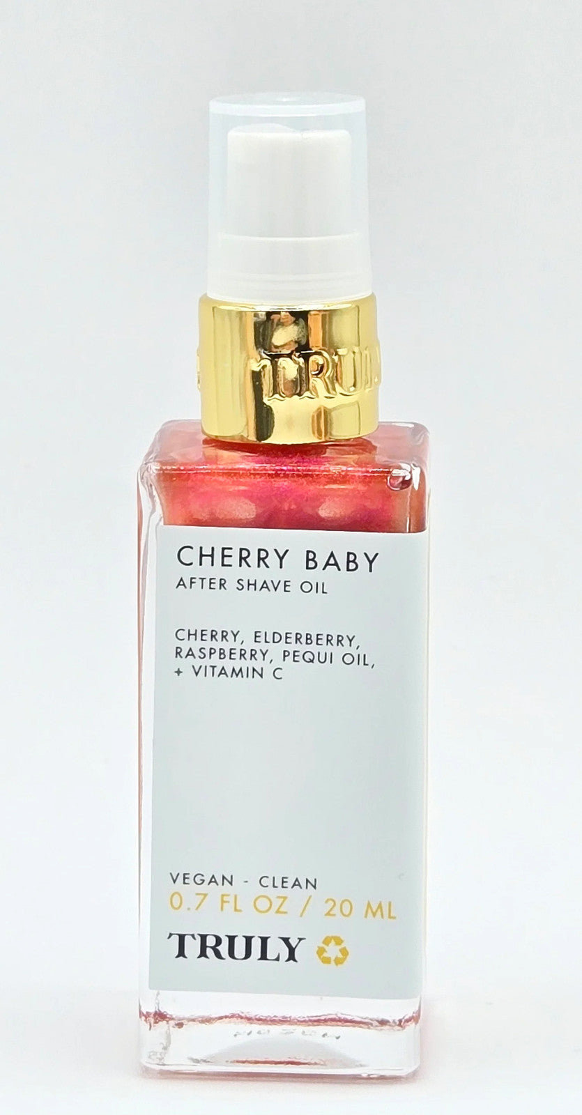 Red pump bottle with gold trim on white background