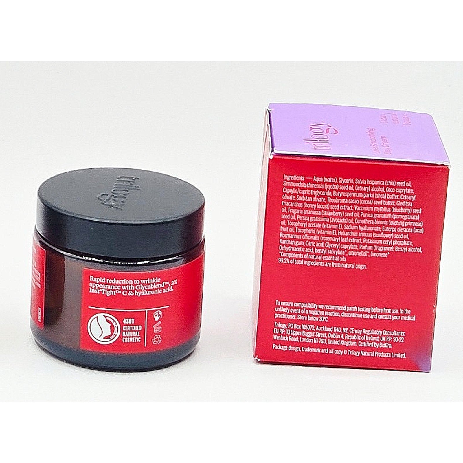 Red jar with black lid and matching red box on a white background