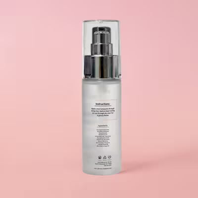 Back of Sleek’e Silk’e Repair Therapy Hair Serum bottle showing directions and ingredient label on pink