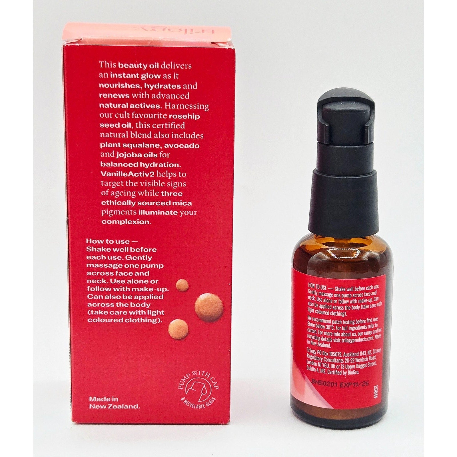 Skincare serum bottle with red packaging on a white background