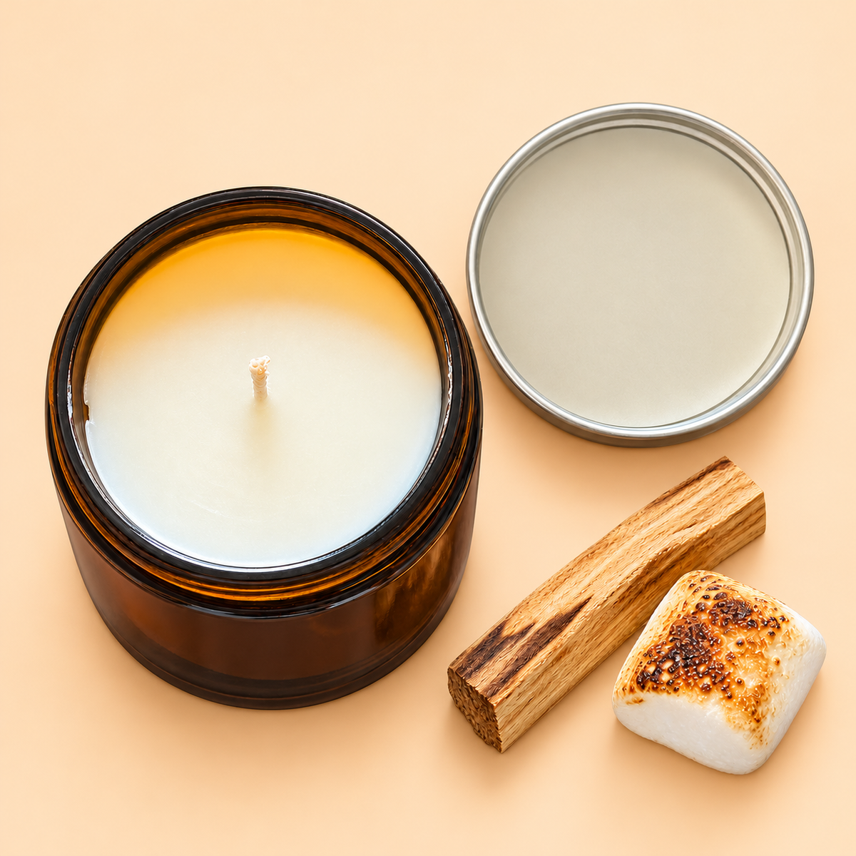 Open Siblings No. 13 candle with lid, palo santo stick and toasted marshmallow on a pale orange background.