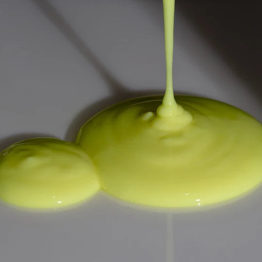 Close-up of Odacité Derm-Restore serum pooling beneath a dropper