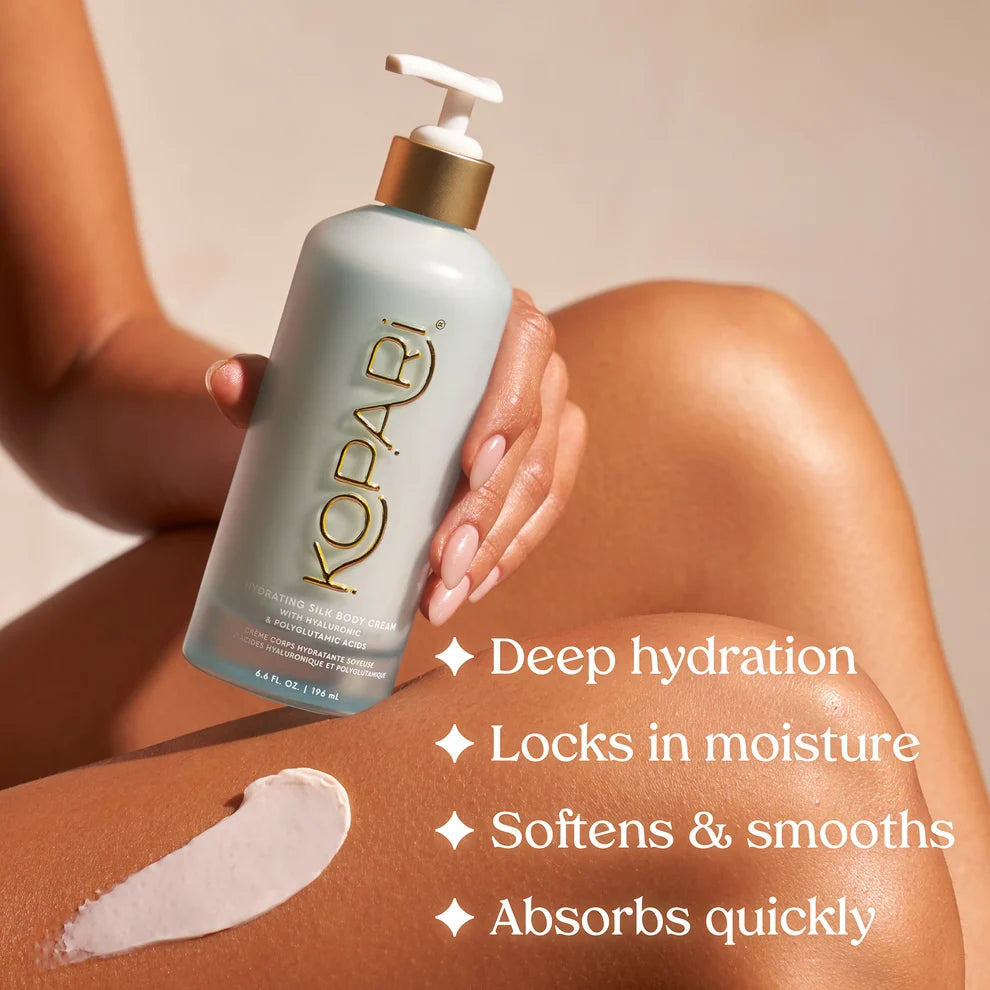 Kopari Hydrating Silk Body Cream held against skin with deep hydration and smoothing benefits