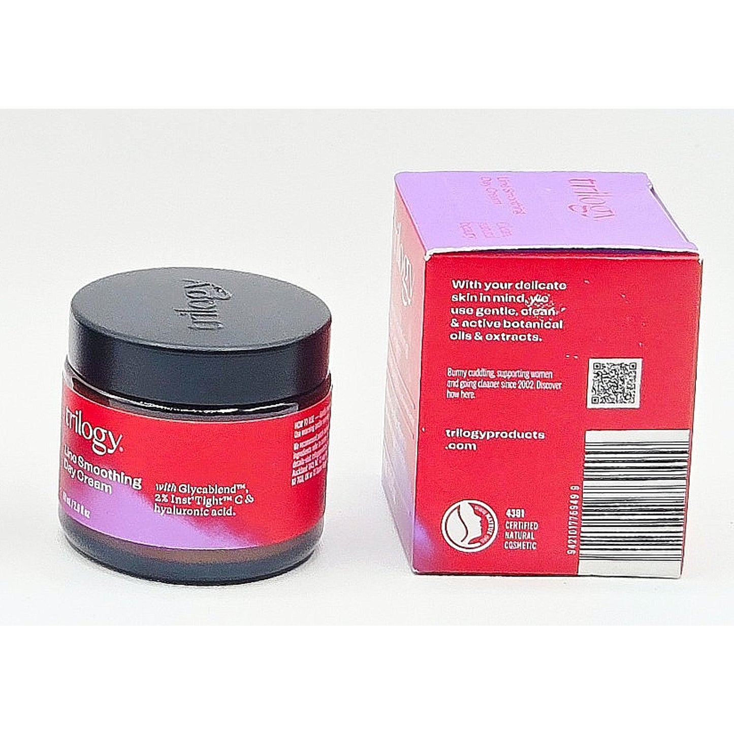 Red jar and box of Trilogy skincare product on a white background