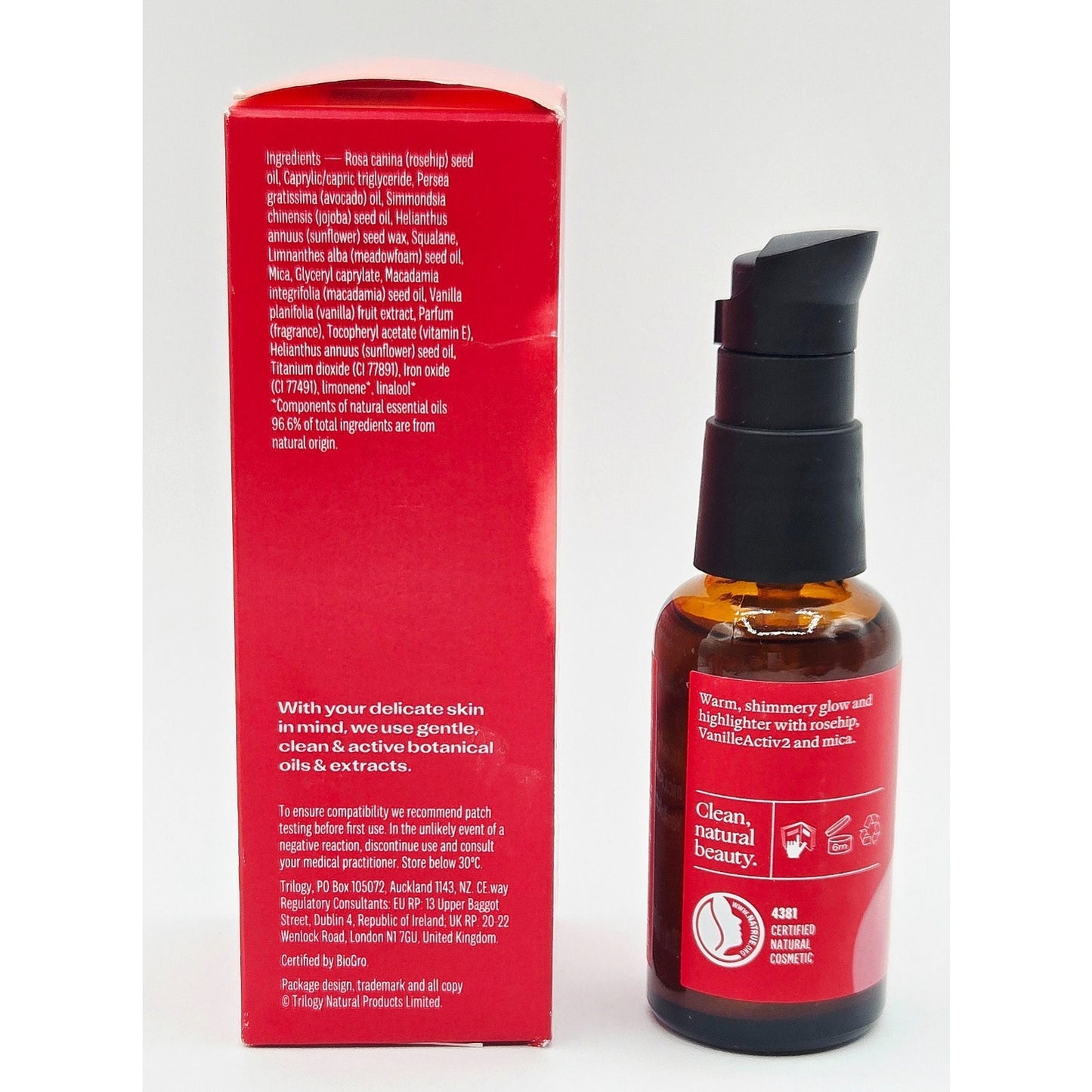Skincare bottle with red label and packaging on a white background