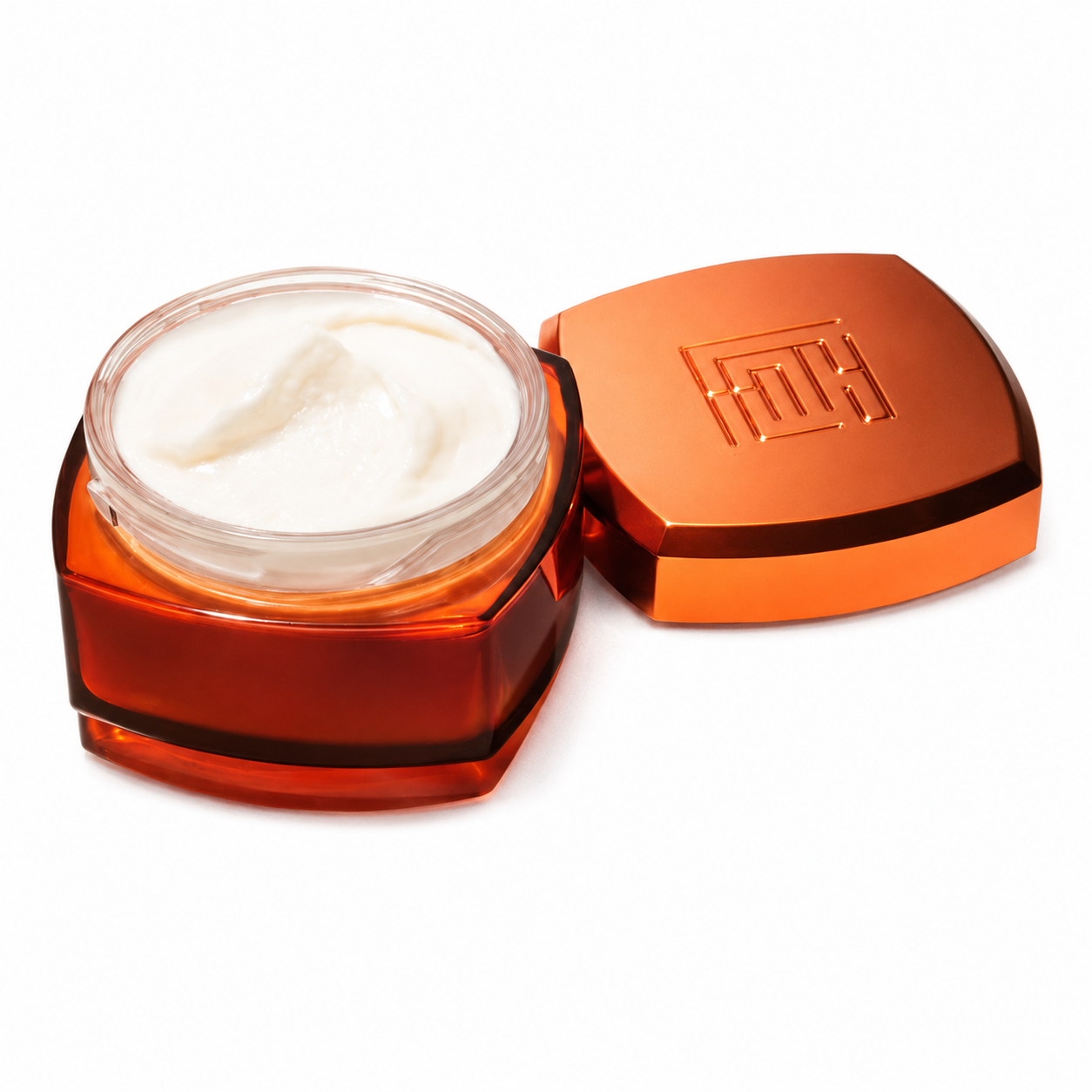 An open jar of white cream or balm in a translucent amber-brown container with a matching metallic orange lid placed beside it on a clean white background.