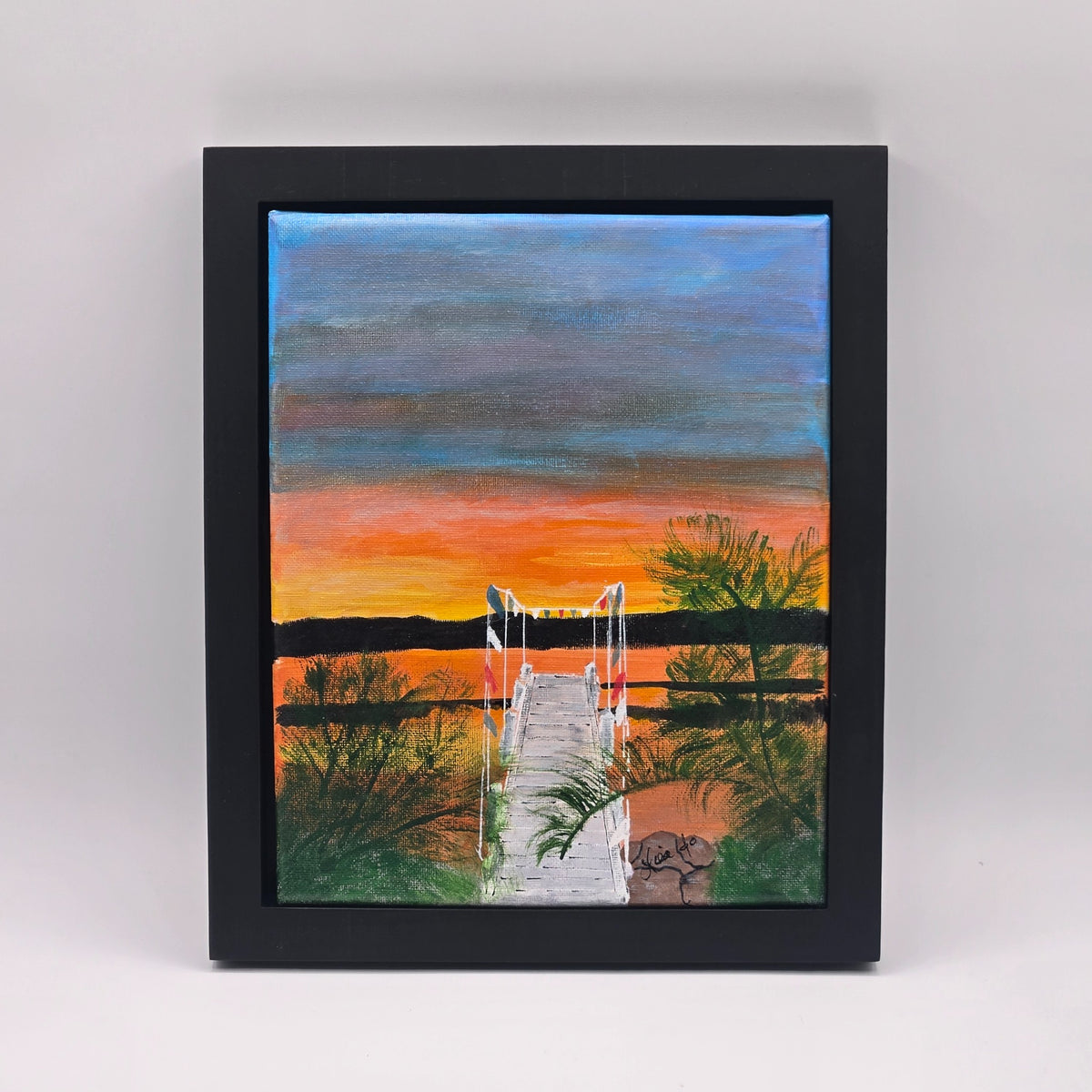 Framed original acrylic painting Mars Resort Pier showing a narrow dock beneath a vivid orange and blue sunset