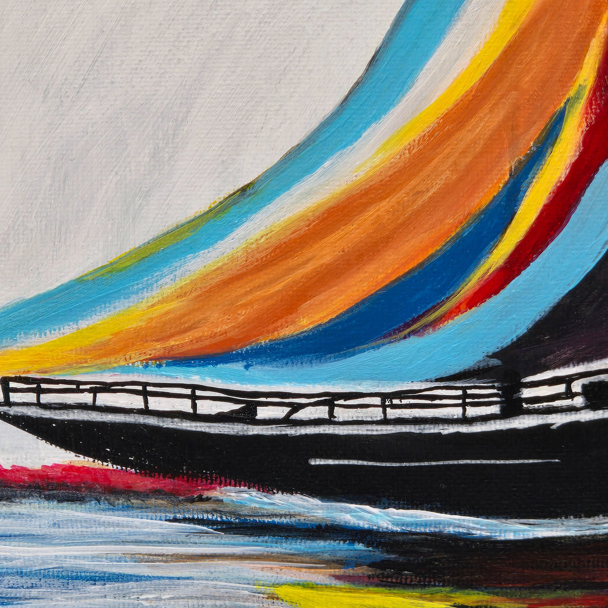 Detail of the blue, orange, and yellow sails and black hull in Painted Sails