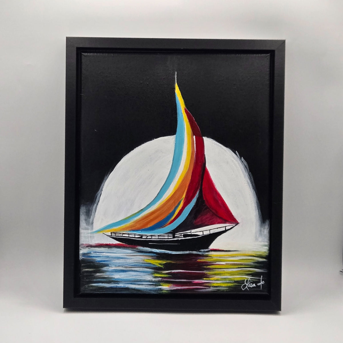 Framed original acrylic painting Painted Sails showing a black sailboat with sweeping colorful sails