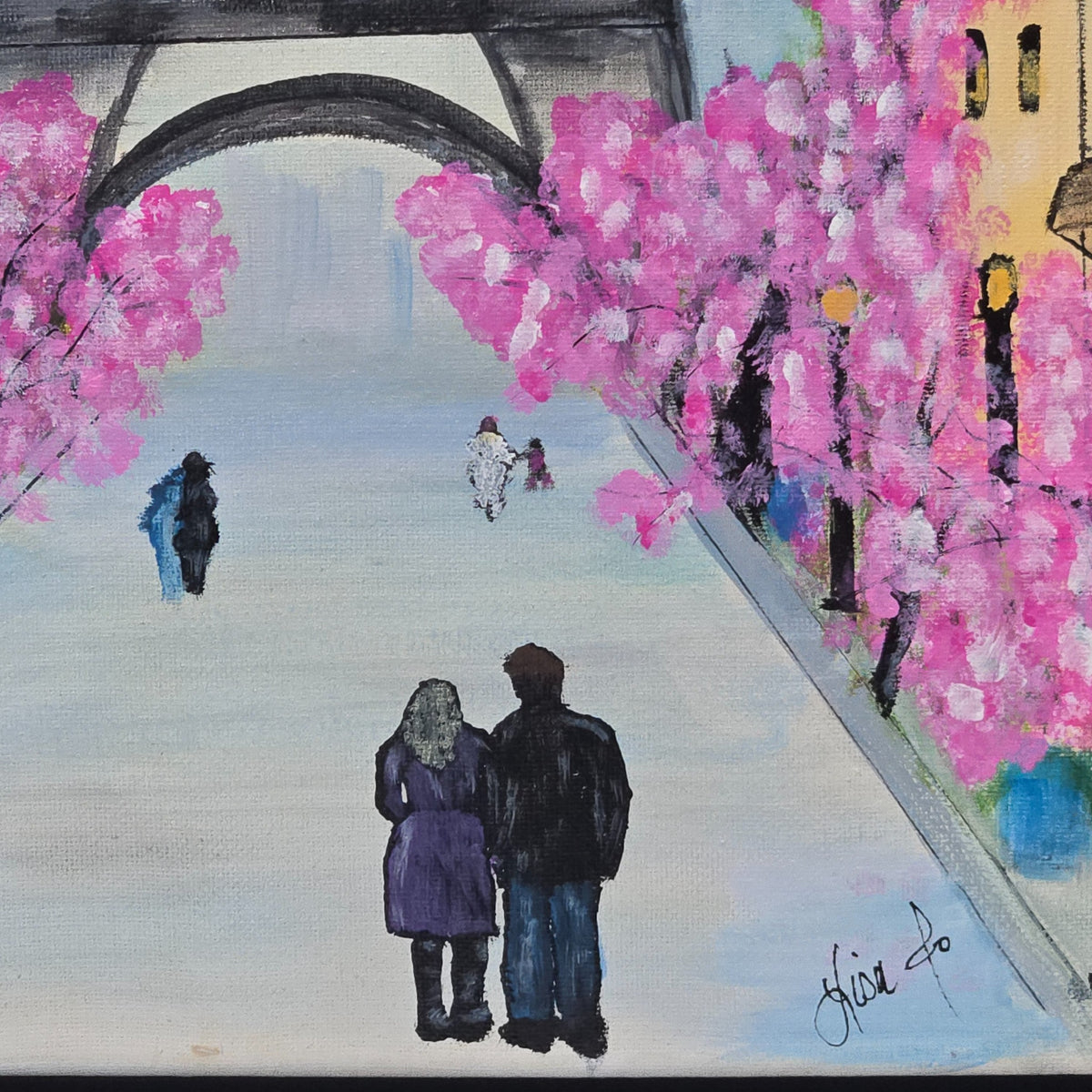 Detail of figures walking beneath pink blossoms and Lisa Jo's signature in Paris in Pink